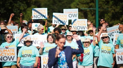 In this July 29, 2014, file photo, clean air advocates cheer as Mary Anne Hitt, director of the Sierra Club's Beyond Coal Campaign, speaks at a rally outside an Environmental Protection Agency hearing in Atlanta. Sierra Club lawyers who've preached against the environmental evils of coal-burning power plants for decades are trying to force the closure of the last significant one in renewable energy-rich Nevada with arguments based on a different sort of green: money.