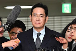 In this Feb. 13, 2017 file photo, Lee Jae-yong, center, vice chairman of Samsung Electronics, arrives to be questioned as a suspect in a corruption scandal at the office of the independent counsel in Seoul. Lee, the billionaire Samsung Group heir, will stand trial on Thursday, March 9 at a Seoul court. He is charged with, among other offenses, offering bribes to President Park Geun-hye and a close friend of hers to strengthen his control over Samsung, the conglomerate founded by his grandfather that is South Korea’s largest and most successful business.