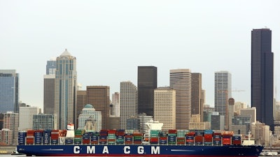 In this Monday, Feb. 29, 2016, photo, the CMA CGM Benjamin Franklin is towed to Seattle's Terminal 18. The vessel is 1,300 feet long, 177 feet wide, 197 feet high and can carry up to 18,000 containers. On Tuesday, March 7, 2017, the Commerce Department reports on the U.S. trade deficit for January.