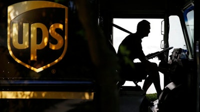 In this June 20, 2014, file photo, a United Parcel Service driver starts his truck after making a delivery in Cumming, Ga. On Friday, March 24, 2017, a federal judge ruled that UPS ignored 'red flags' that its brown trucks were being used to transport untaxed cigarettes from Indian reservations, but stopped short of imposing a $873 million penalty that regulators sought in the civil case.
