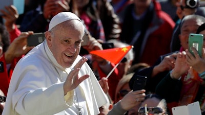 Pope Francis waves as he arrives for his weekly general audience in St. Peter square at the Vatican, Wednesday, March 15, 2017.