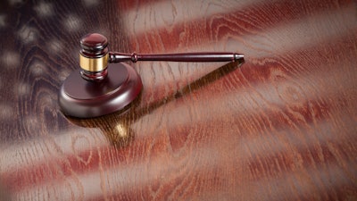 Wooden Gavel Resting On Flag Reflecting Table 498974795 1256x838 58cc0031e94c1