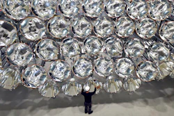 In this March 21, 2017 photo engineer Volkmar Dohmen stands in front of xenon short-arc lamps in the DLR German national aeronautics and space research center in Juelich, western Germany. The lights are part of an artificial sun that will be used for research purposes.
