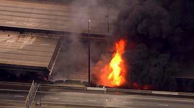 In this aerial image made from a video provided by WSB-TV, a large fire that caused an overpass on Interstate 85 to collapse burns in Atlanta, Thursday, March 30, 2017. Witnesses say troopers were telling cars to turn around on the bridge because they were concerned about its integrity. Minutes later, the bridge collapsed.