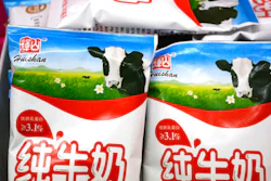 In this Saturday, March 25, 2017 photo, bags of Huishan milk sit on a shelf in a grocery store in Shenyang in northeastern China's Liaoning province. China Huishan Dairy Holdings Co., a Chinese dairy company, whose stock plunged last week, wiping billions off its market value, denied rumors Tuesday, March 28 of forged invoices and misappropriated funds, but also said it can't contact a key executive.