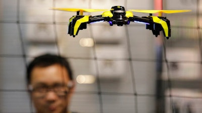 In this Jan. 5, 2017 file photo, a drone flies in Las Vegas. The world’s largest manufacturer of civilian drones is proposing that drones be required to continually transmit identification information to help government security agencies and law enforcement figure out which might belong to rogue operators.