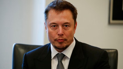 In this Dec. 14, 2016, file photo, Tesla CEO Elon Musk listens as President-elect Donald Trump speaks during a meeting with technology industry leaders at Trump Tower in New York., Musk promised on Twitter March 9, 2017, to solve an energy crisis in Australia or his company’s services are free.