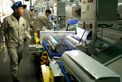 In this Friday, Feb. 24, 2017 photo, factory workers check air conditioners on an assembly line at a Haier factory in Jiaozhou near Qingdao in eastern China's Shandong Province. Zhang Ruimin built Haier from a failing refrigerator factory in the 1980s into the biggest maker of major appliances. Now, he is trying to transform a traditional manufacturer with 60,000 employees in 25 countries into a nimble, Internet Age seller of consumer goods and services from web-linked washing machines to food delivery.