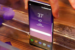 In this Friday, March 24, 2017, photo, a Samsung Galaxy S8 mobile phone is shown partially submerged to demonstrate its water resistance, in New York. The Galaxy S8 features a larger display than its predecessor, the Galaxy S7, and sports a voice assistant intended to rival Siri and Google Assistant.