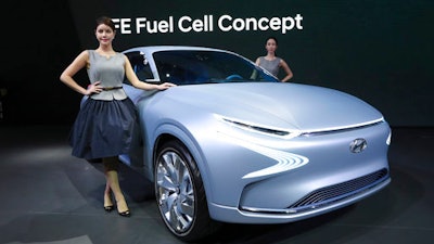 Models pose with Hyundai Motor's FE Fuel Cell Concept car during a media preview of the 2017 Seoul Motor Show in Goyang, South Korea, Thursday, March 30, 2017. The exhibition will be held from March 31 to April 9 with 27 brands showing their latest cars and concepts.