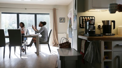 In this photo taken on Monday, Feb. 27, 2017, Spacehop users Lavinia Osbourne, right, and Whitney Fangawa pose for a picture in one of the homes available for hire as office space on the Spacehop website, in London. The rise of self-employment and soaring office costs are fueling demand for shared office space in metropolitan areas, with a handful of firms renting workspace by the hour, similar to the way Airbnb offers overnight stays. Vrumi, founded in 2015, says it has 5,000 registered users and 120,000 square feet of rentable workspace across the U.K. London-based Spacehop joined the market last year, as did Breather, a four-year-old company that also operates in the U.S. and Canada.