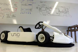 In this Monday, March 13, 2017 photo, a Uniti branded go kart sits in front a white board filled with engineering sketches in the startup’s temporary production facility in Lund, Sweden. A group of Swedish students that raised 1.2 million euros in crowdfunding for their startup to build electric cars has caught the attention of German industrial heavyweight Siemens. The two sides said Wednesday that they were starting a partnership that will see them create 50,000 lightweight city cars a year starting next year.