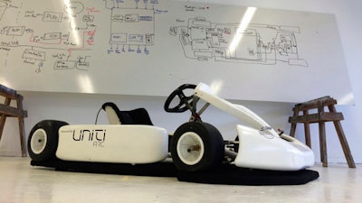In this Monday, March 13, 2017 photo, a Uniti branded go kart sits in front a white board filled with engineering sketches in the startup’s temporary production facility in Lund, Sweden. A group of Swedish students that raised 1.2 million euros in crowdfunding for their startup to build electric cars has caught the attention of German industrial heavyweight Siemens. The two sides said Wednesday that they were starting a partnership that will see them create 50,000 lightweight city cars a year starting next year.