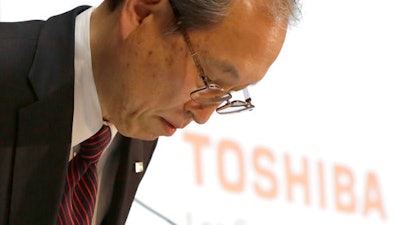 Toshiba Corp. President Satoshi Tsunakawa bows during a press conference at the company's headquarters in Tokyo, Tuesday, March 14, 2017. Troubled Japanese nuclear and electronics company Toshiba said Tuesday it was considering selling its money-losing Westinghouse operations in the U.S.