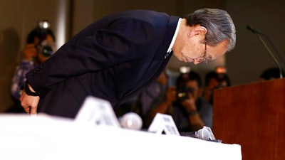 Toshiba Corp. President Satoshi Tsunakawa bows during a press conference at the company's headquarters in Tokyo, Wednesday, March 29, 2017. Japan's embattled Toshiba said Wednesday that its U.S. nuclear unit Westinghouse Electric Co. has filed for bankruptcy protection. Toshiba said in a statement that it filed the chapter 11 petition in the U.S. Bankruptcy Court of New York.