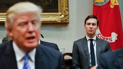In this Monday, Jan. 23, 2017, file photo, White House Senior Adviser Jared Kushner, right, listens to President Donald Trump speak during a breakfast with business leaders in the Roosevelt Room of the White House in Washington. Trump is set to announce a new White House office run by his son-in-law, Kushner, that will seek to overhaul government functions using ideas from the business sector.