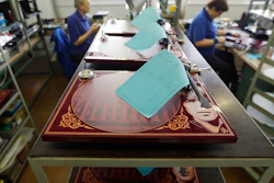 In this picture taken on Tuesday Feb. 28, 2017 in Litovel, Czech Republic, George Harrisson commemorative turntables are being manufactured at the SEV Litovel turntable factory. The company is considered the biggest maker of quality turntables in the world and has been increasing output year after year with the end of the market surge nowhere in sight.