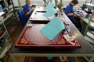 In this picture taken on Tuesday Feb. 28, 2017 in Litovel, Czech Republic, George Harrisson commemorative turntables are being manufactured at the SEV Litovel turntable factory. The company is considered the biggest maker of quality turntables in the world and has been increasing output year after year with the end of the market surge nowhere in sight.