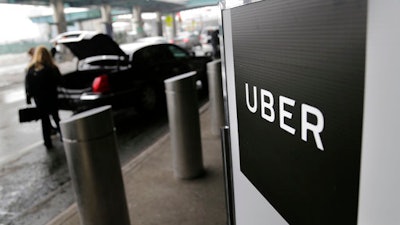 In this Wednesday, March 15, 2017 file photo, a sign marks a pick-up point for the Uber car service at LaGuardia Airport in New York. Jeff Jones, president of the embattled ride-hailing company Uber, has resigned just six months after taking the job, the company confirmed Sunday, March 19.