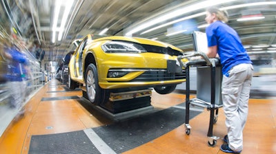 In this March 9, 2017 file photo, an employee works at the assembly line for Golf 7 cars in the Volkswagen factory in Wolfsburg, Germany. The annual news conference of Volkswagen takes place on Tuesday March 14, 2017 in Wolfsburg.