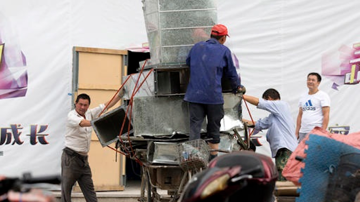 Workers remove air ducts made from aluminum sheet metal in Beijing, China. In September, China’s leaders promised to rein in aluminum production that is flooding global markets and threatening jobs in the United States and Europe. Since then the industry has found its way into the crosshairs of the Trump administration.