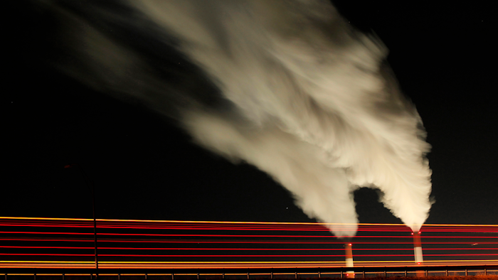 In this Jan. 19, 2012 file photo, smoke rises in this time exposure image from the stacks of the La Cygne Generating Station coal-fired power plant in La Cygne, Kan. The Environmental Protection Agency on Tuesday, April 18, 2017, asked a federal appeals court in Washington to postpone consideration of 2012 rules requiring energy companies to cut emissions of toxic chemicals.