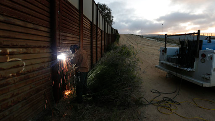 One potential bidder on President Donald Trump's border wall with Mexico wanted to know if the government would help if its workers came under 'hostile attack.' With bids due Tuesday, April 4, 2017, on the first design contracts, companies are preparing for the worst if they get the potentially lucrative but controversial job.