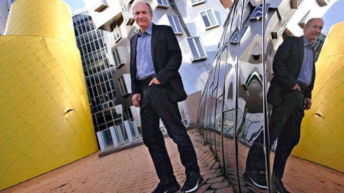In this Monday, April 3, 2017, photo, Tim Berners-Lee poses outside his office at the Massachusetts Institute of Technology in Cambridge, Mass. Berners-Lee, best known as the inventor of the World Wide Web, is this year's recipient of the A.M. Turing Award, computing's version of the Nobel Prize. The honor comes with a $1 million prize funded by Google, one of many companies that made a fortune thanks to Berners-Lee's efforts to make the internet more accessible and useful.