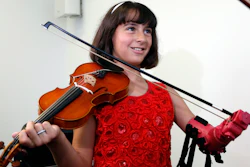Ten-year-old Isabella Nicola Cabrera smiles after playing her violin with her new prosthetic at the engineering department of George Mason University in Fairfax, Va., Thursday, April 20, 2017. 'Oh my gosh, that's so much better,' Isabella said as she tried out the new prosthetic.