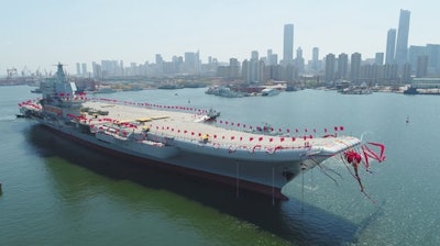 In this photo released by China's Xinhua News Agency, a newly-built aircraft carrier is transferred from dry dock into the water at a launch ceremony at a shipyard in Dalian in northeastern China's Liaoning Province, Wednesday, April 26, 2017. China launched its first aircraft carrier built entirely on its own on Wednesday, in a demonstration of the growing technical sophistication of its defense industries and determination to safeguard its maritime territorial claims and crucial trade routes.