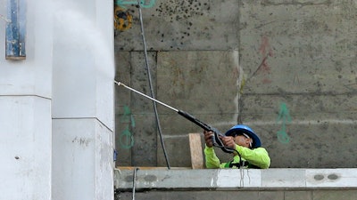 In this photo, a construction worker works on a high-rise condominium project on Biscayne Boulevard, in downtown Miami.