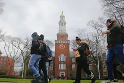 FILE - In this Feb. 1, 2017, file photo, Brooklyn College students walk between classes on campus in New York. The New York state Legislature approved a budget on April 9, 2017, that includes funding for Democratic Gov. Andrew Cuomo's plan to offer free tuition for middle class students at state universities.
