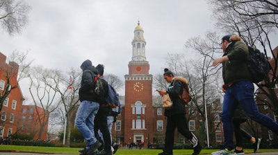 FILE - In this Feb. 1, 2017, file photo, Brooklyn College students walk between classes on campus in New York. The New York state Legislature approved a budget on April 9, 2017, that includes funding for Democratic Gov. Andrew Cuomo's plan to offer free tuition for middle class students at state universities.