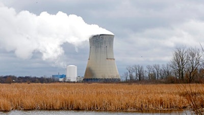 In this April 4, 2017, file photo, plumes of steam drift from the cooling tower of FirstEnergy Corp.'s Davis-Besse Nuclear Power Station in Oak Harbor, Ohio. FirstEnergy Corp. President Chuck Jones is telling state lawmakers that a proposal to keep alive its two nuclear plants along Lake Erie is more than just a bailout. Jones said the plants need to keep operating to ensure Ohio has a diverse lineup of homegrown energy sources and that electricity prices aren't vulnerable to wild swings.