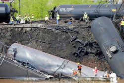 In this May 1, 2014, file photo survey crews in boats look over tanker cars as workers remove damaged tanker cars along the tracks where several CSX tanker cars carrying crude oil derailed and caught fire along the James River near downtown Lynchburg, Va. Inspectors have found almost 24,000 safety defects over a two-year period along United States railroad routes used to ship volatile crude oil. Data obtained by The Associated Press shows many of the defects were similar to problems blamed in past derailments that caused massive fires or oil spills in Oregon, Virginia and Montana.