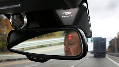 This Wednesday, Oct. 14, 2015, file photo shows a Mobileye camera system that can be installed in your car to monitor speed limits and warn drivers of potential collisions, mounted behind the rearview mirror during a demonstration of the system, in Ann Arbor, Mich. For a few hundred dollars, drivers can add new safety technology, like forward collision warning systems or backup cameras, to older cars. Cars are lasting longer than ever thanks to improving quality. The average U.S. vehicle is now 11.6 years old, according to the consulting firm IHS Markit.