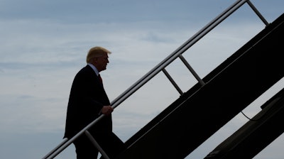 President Donald Trump walks up the steps of Air Force One at General Mitchell International Airport in Milwaukee, Tuesday, April 18, 2017. Trump went to Kenosha, Wis., to visit the headquarters of tool manufacturer Snap-on Inc., and sign an executive order that seeks to make changes to a visa program that brings in high-skilled workers.