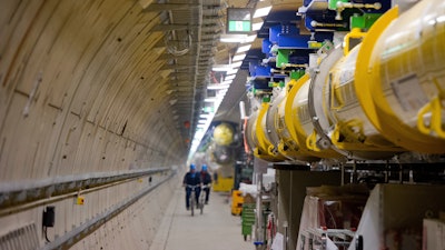 In this Feb. 18, 2015 file photo employees ride their bicycles inside the particle accelerator tunnel of the X-ray laser-project European XFEL on the outskirts of Hamburg, Germany. Researchers said Wednesday, April 19, 2017 they have reached a significant milestone on the path to beginning scientific operations later this year.
