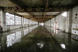 In this photo taken on Friday, Feb. 3, 2017, water comes from the roof inside the abandoned Alfa Romeo car factory, in Arese, near Milan, Italy, Friday, Feb. 3, 2017. Lombardy is Italy's most productive region with an annual GDP of 337 billion euros, making it Europe's second most productive region. And yet the landscape is dotted with ghosts of industries past.