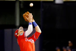 In this March 15, 2017, file photo, Philadelphia Phillies second baseman Chris Coghlan catches a pop fly in the fifth inning of a spring training baseball game in Tampa, Fla. Coghlan spent spring training with the Phillies using a wrist band to measure his sleep and recovery.
