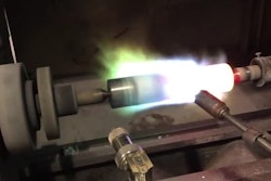 To prime the stainless steel plunger barrel for coating, the plunger is mounted onto a coating lathe, where the spray gun preheats it to over 400°F.