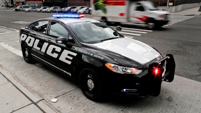 In this Friday, April 7, 2017, photo, a prototype of the Ford Fusion police hybrid car sits along 11th Avenue in New York. Ford Motor Co., which sells more police cars in the U.S. than any other automaker, says it will offer a police pursuit version of the hybrid Fusion midsize sedan, in response to requests from cities nationwide.