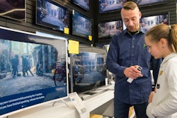 In this photo taken Saturday, April 15, 2017, Salome Sigurjonsdottir, 10, tests a voice-controlled television in an electronics store in Reykjavik. Sales assistant Einar Dadi said none of his TVs understood Icelandic. The revered Icelandic language, seen by many as a source of identity and pride, is being undermined by the widespread use of English both for mass tourism and in the voice-controlled artificial intelligence devices coming into vogue.