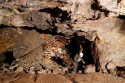 In this picture taken on Wednesday, March 22, 2017, Otto Janout, a prospector and one of the four founders of Geomet company, picks up a piece of ore containing lithium inside a former mine located at the border with Germany near the village of Cinovec, Czech Republic. An expected massive surge in demand for the Lithium metal means a revival of centuries-long mining tradition in the area.