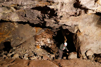 In this picture taken on Wednesday, March 22, 2017, Otto Janout, a prospector and one of the four founders of Geomet company, picks up a piece of ore containing lithium inside a former mine located at the border with Germany near the village of Cinovec, Czech Republic. An expected massive surge in demand for the Lithium metal means a revival of centuries-long mining tradition in the area.