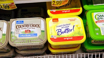 Containers of I Can't Believe It's Not Butter and Country Crock spreads appear on display in a grocery store cooler, Thursday, April 6, 2017, in Bellevue, Wash. Margarine's fortunes seem to be taking another sad turn, with the owner of the products looking for someone to take the brands off its hands. Consumer products heavyweight Unilever said it's seeking to unload its spreads business that has suffered from soft sales in the United States and other developed markets.