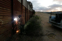 One potential bidder on President Donald Trump's border wall with Mexico wanted to know if the government would help if its workers came under 'hostile attack.' With bids due Tuesday, April 4, 2017, on the first design contracts, companies are preparing for the worst if they get the potentially lucrative but controversial job.