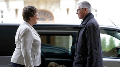 Carlos Tavares, CEO of PSA Peugeot Citroen, right, and German Minister for Economic Affairs and Energy, Brigitte Zypries, left, talk as they arrive for a meeting in Berlin, Germany, Wednesday, April 5, 2017.