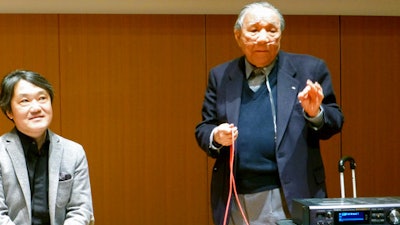 In this Jan. 11, 2013 photo, Ikutaro Kakehashi, right, speaks next to composer Akira Senju during a press conference after he received a Grammy, for developing MIDI, or Musical Instrumental Digital Interface, technology, which digitally connects instruments, in Hamamatsu, central Japan. Kakehashi, who pioneered digital music and founded synthesizer giant Roland Corp., has died, his company ATV Corp. said Monday, April 3, 2017. He was 87.