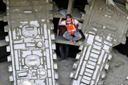 A worker pumps his fists as he stands between the cutting blades of a massive tunneling machine after it broke through a five-foot wide concrete wall to complete boring for the State Route 99 highway, Tuesday, April 4, 2017, under Seattle. After tunneling more than 9,000 feet and building an outer tunnel wall as it moved forward, the boring machine finished digging what will be a two-mile, double-decker traffic tunnel to replace the Alaskan Way viaduct, damaged in an earthquake in 2001.